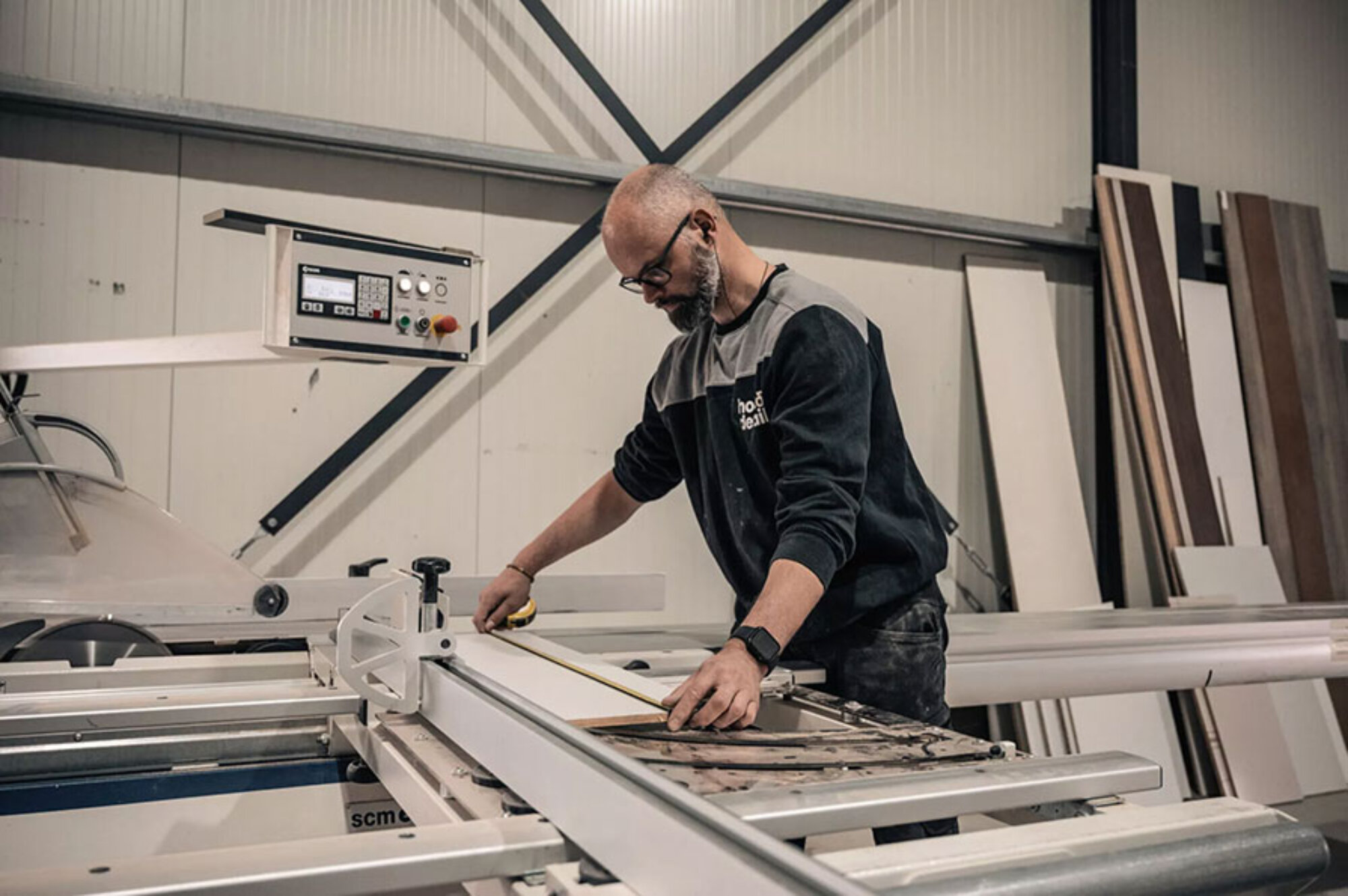 Houtbewerker die aan het werk is en Clientbox gebruikt om zijn bedrijf te runnen.